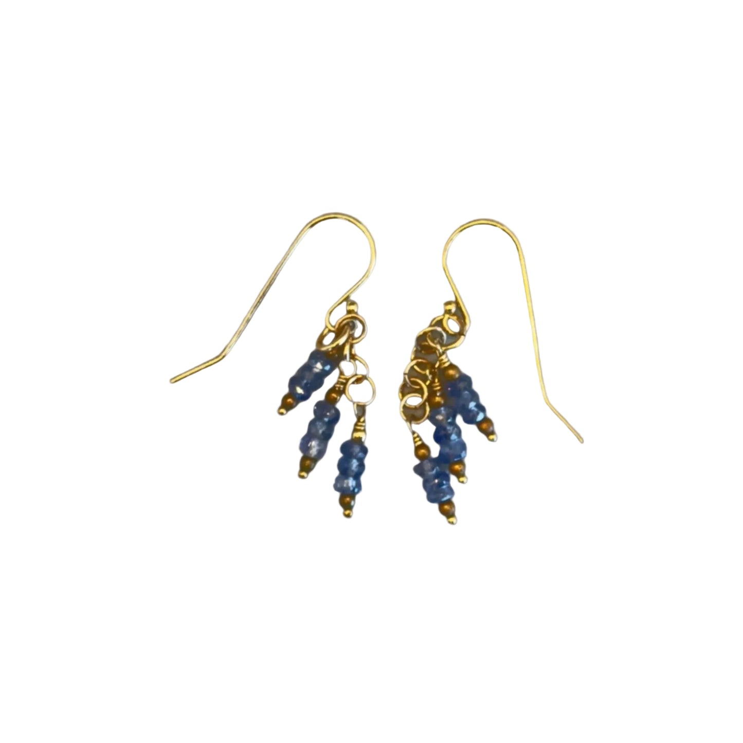 A pair of gold-colored dangle earrings with blue iolite beads and gold-filled wire.